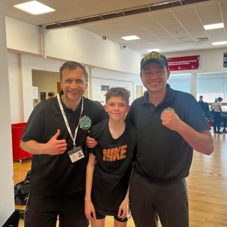 coaches kieran and tom with a fighter at a boxing show